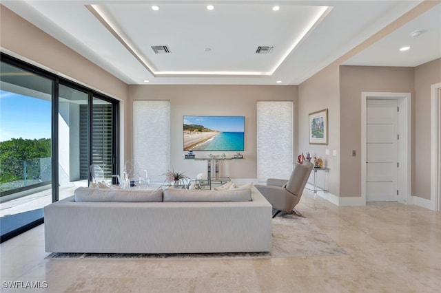 living room featuring a raised ceiling