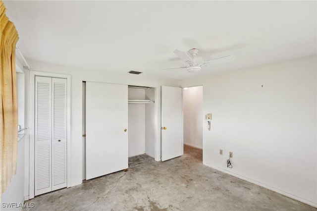 unfurnished bedroom featuring ceiling fan and multiple closets