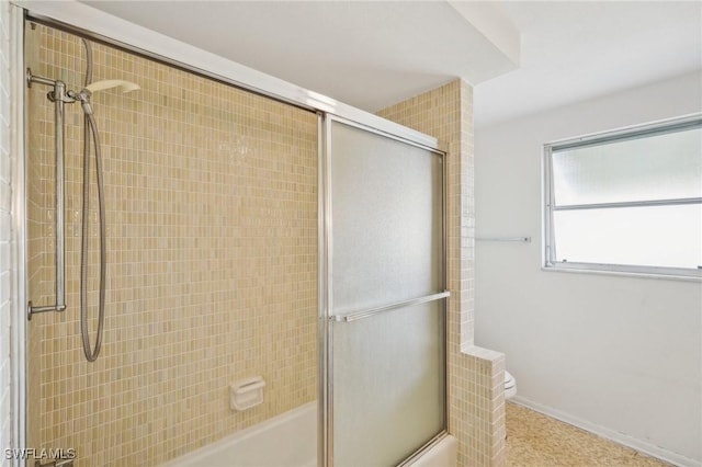 bathroom featuring toilet and enclosed tub / shower combo