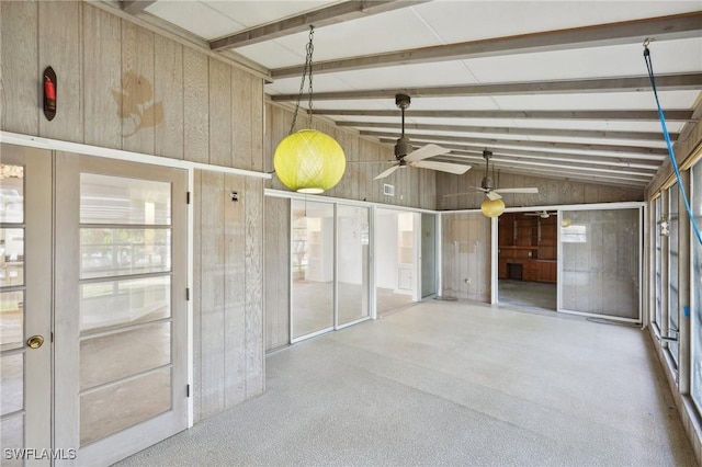 garage with ceiling fan and wooden walls