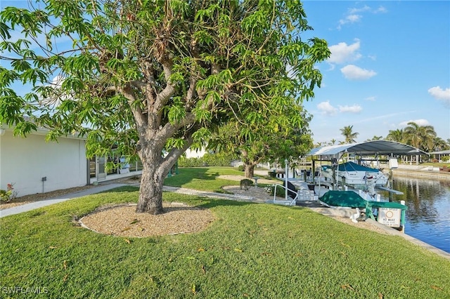 view of yard with a dock and a water view