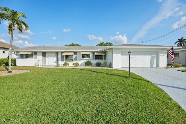 ranch-style house featuring a front yard and a garage