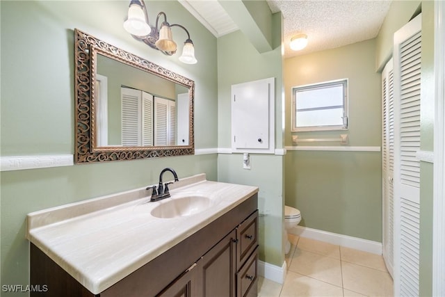 bathroom with tile patterned floors, vanity, toilet, and a textured ceiling