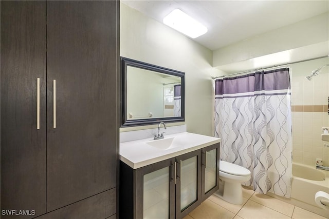 full bathroom with tile patterned flooring, shower / tub combo, vanity, and toilet