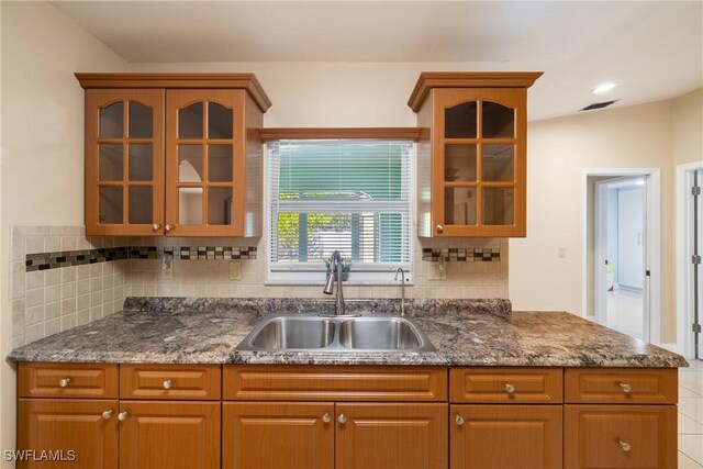 kitchen featuring lofted ceiling and sink