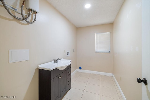 interior space with tile patterned flooring, vanity, and a textured ceiling