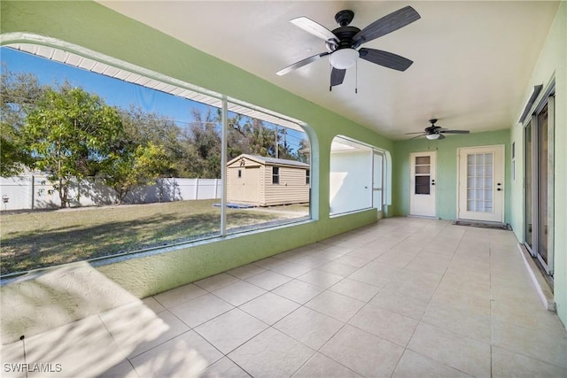 unfurnished sunroom with a ceiling fan