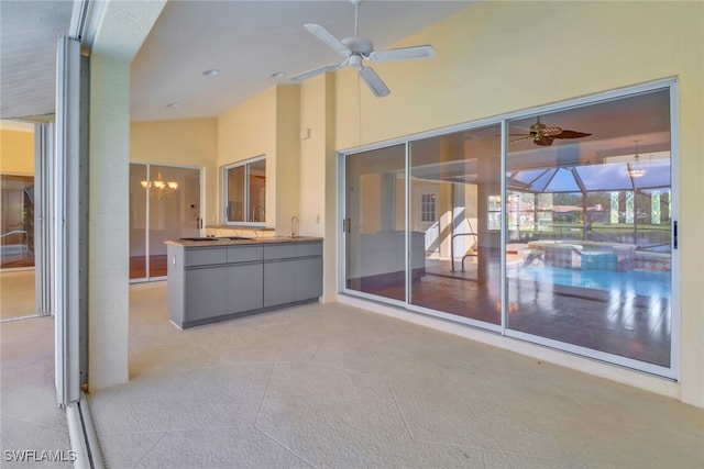 view of patio / terrace featuring a lanai, ceiling fan, and sink