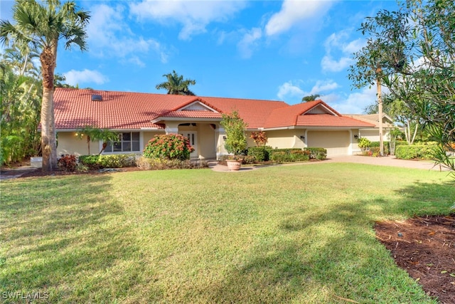 view of front of home featuring a garage and a front yard