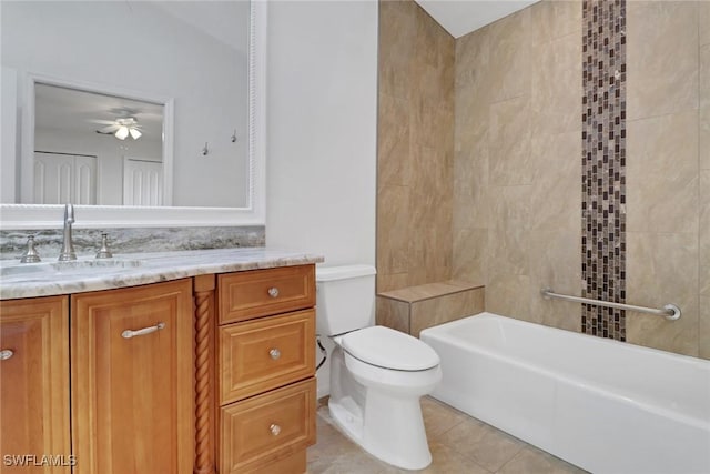 bathroom with vanity, tile patterned floors, ceiling fan, toilet, and a tub to relax in