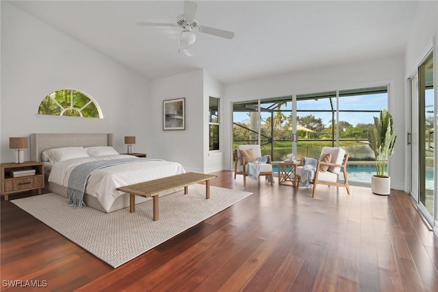 bedroom featuring access to exterior, ceiling fan, a water view, and dark hardwood / wood-style floors