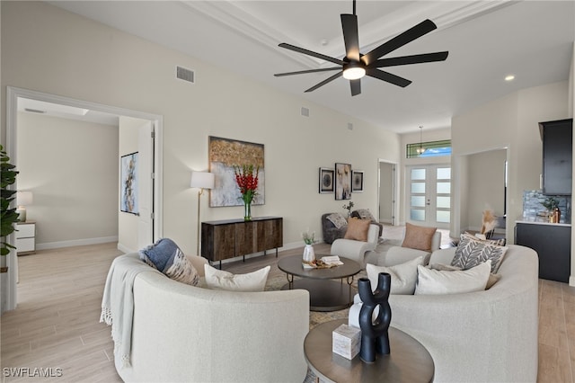 living room with light hardwood / wood-style flooring and ceiling fan