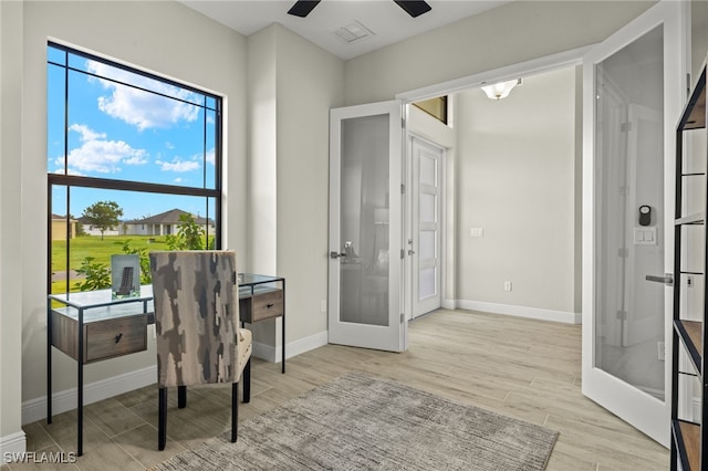 home office featuring french doors and ceiling fan