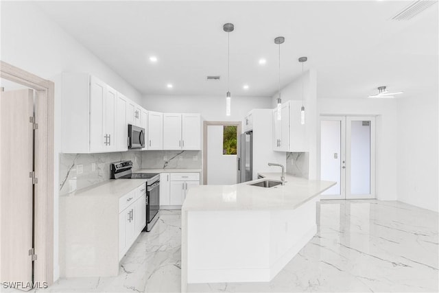 kitchen with white cabinets, hanging light fixtures, sink, and appliances with stainless steel finishes