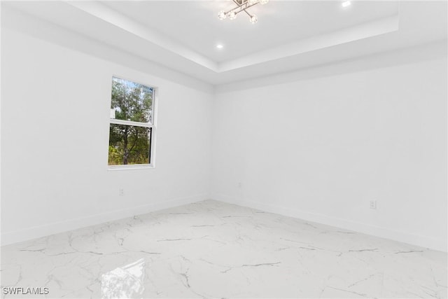 spare room featuring a tray ceiling