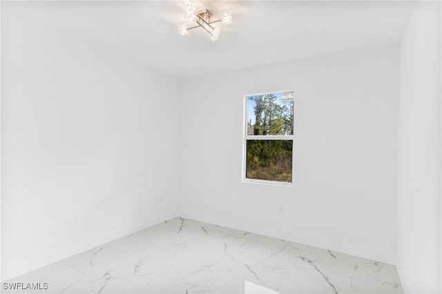 empty room with a wealth of natural light and a chandelier