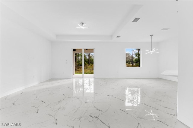 empty room featuring a tray ceiling