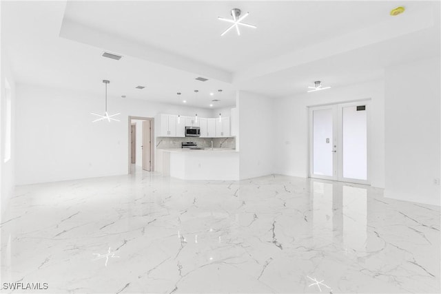 unfurnished living room with french doors