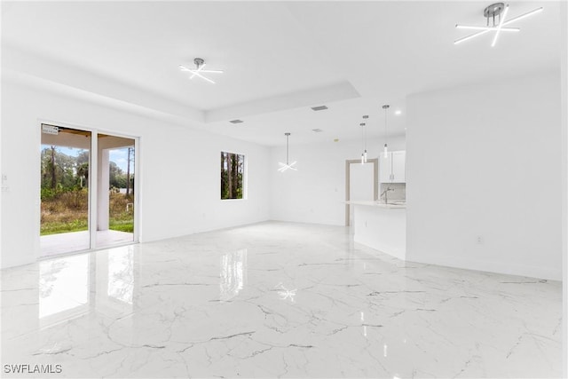 unfurnished room with a tray ceiling