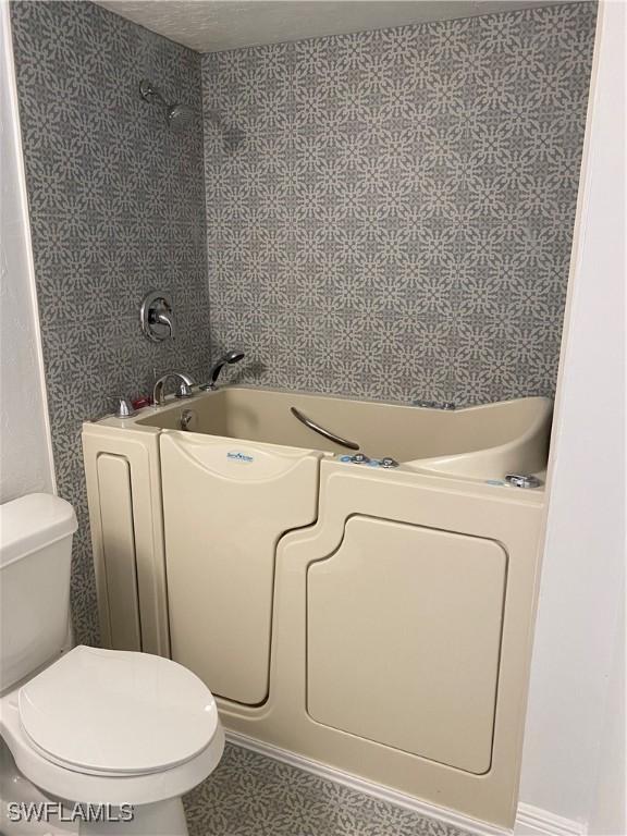 bathroom with tile patterned floors and toilet