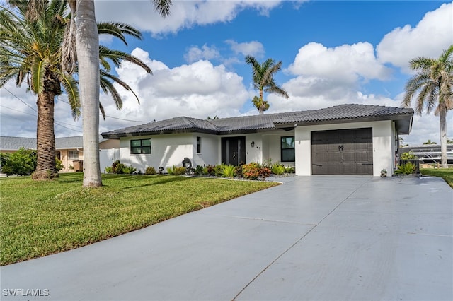 view of front of house featuring a garage and a front yard