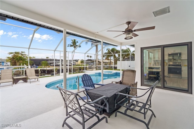 exterior space featuring ceiling fan and a pool