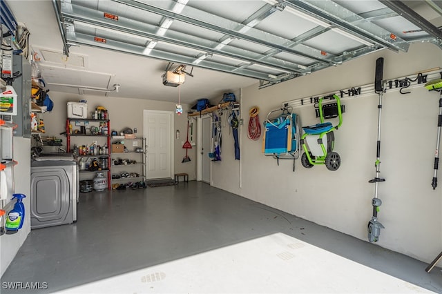 garage with a garage door opener and washer / dryer