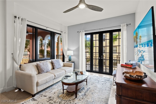 tiled living room featuring ceiling fan and french doors