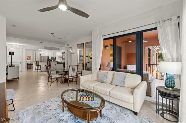 living room with ceiling fan with notable chandelier and light tile patterned flooring