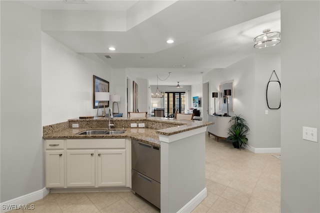 kitchen featuring kitchen peninsula, sink, stone countertops, dishwasher, and white cabinets