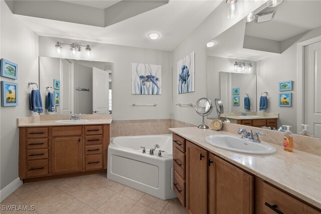 bathroom with vanity, tile patterned floors, and a tub