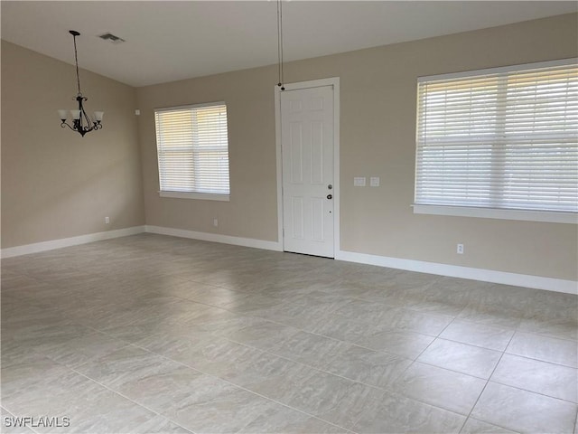 tiled spare room featuring vaulted ceiling and an inviting chandelier