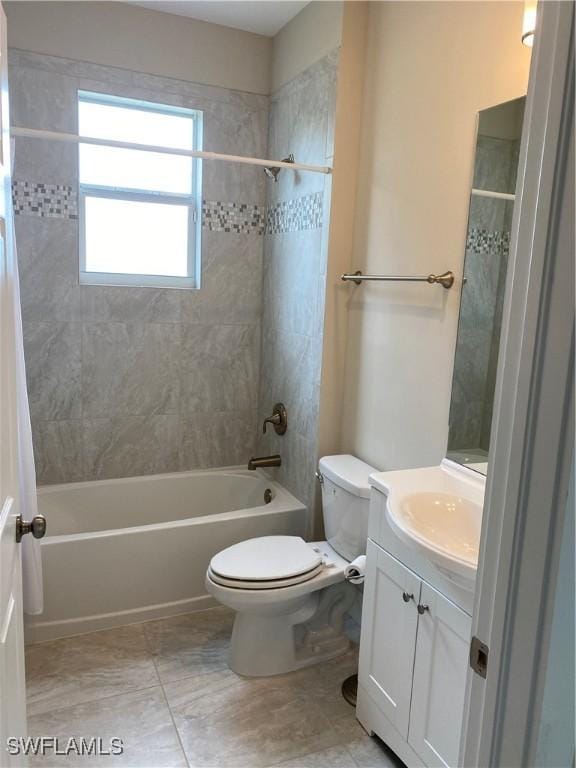 full bathroom with tile patterned flooring, vanity, toilet, and tiled shower / bath