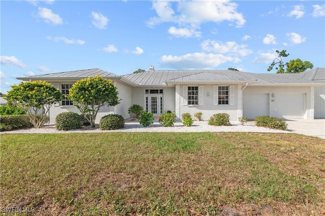 single story home with a garage and a front lawn