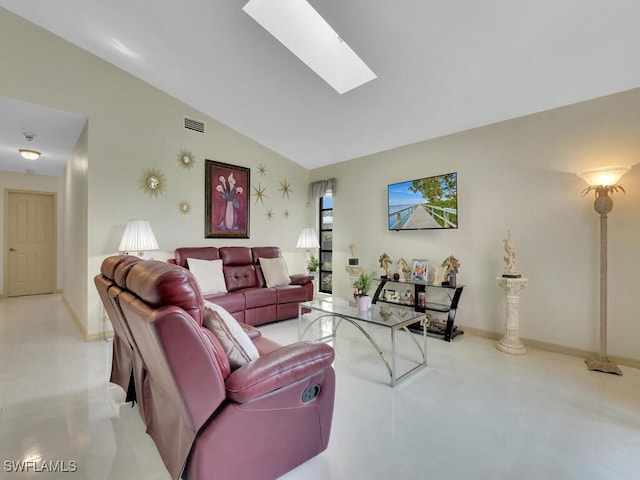 living room with vaulted ceiling with skylight