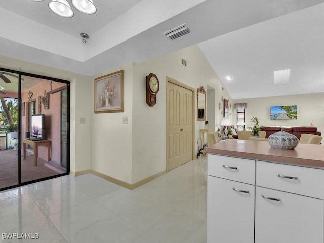 kitchen featuring white cabinets and lofted ceiling