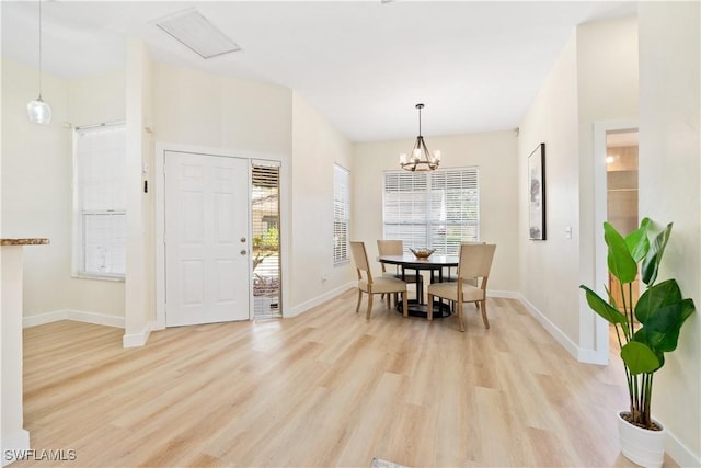 dining room featuring light hardwood / wood-style flooring and a notable chandelier