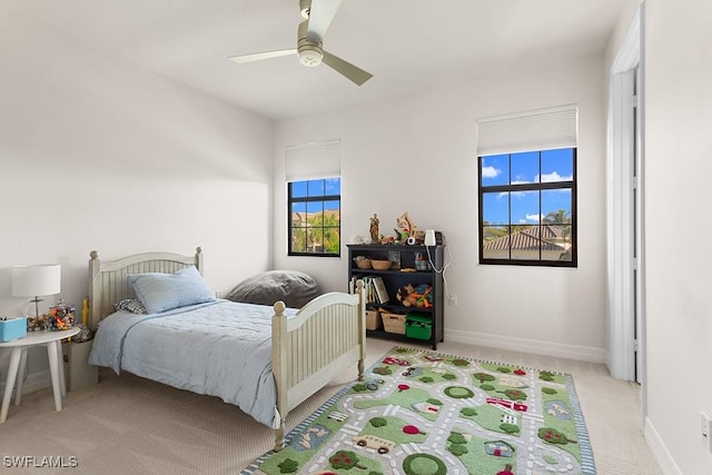 bedroom featuring light carpet and ceiling fan