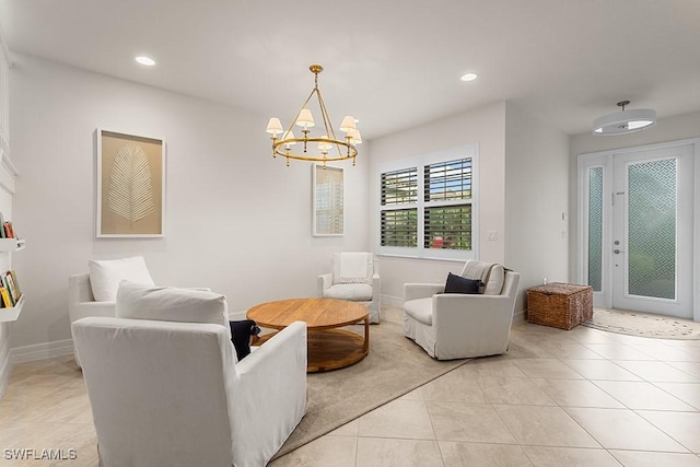 living room featuring a notable chandelier and light tile patterned floors