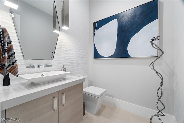 bathroom featuring tile patterned flooring, vanity, toilet, and tasteful backsplash