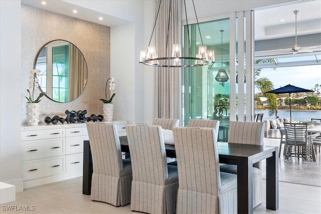 dining space featuring ceiling fan with notable chandelier