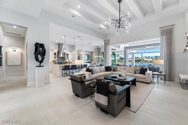 tiled living room featuring a towering ceiling, beamed ceiling, and a notable chandelier