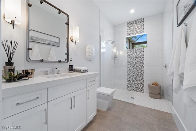 bathroom featuring toilet, vanity, and tiled shower