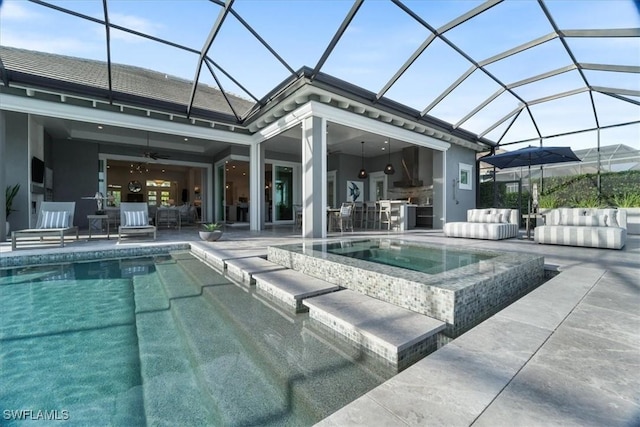 view of pool featuring an in ground hot tub, a patio, ceiling fan, and a lanai