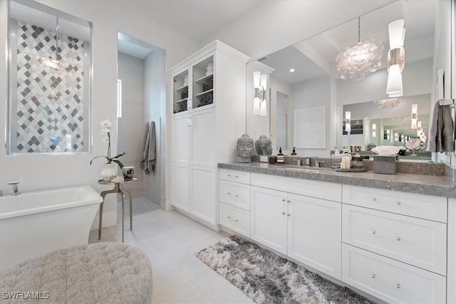 bathroom with tile patterned flooring, vanity, and independent shower and bath