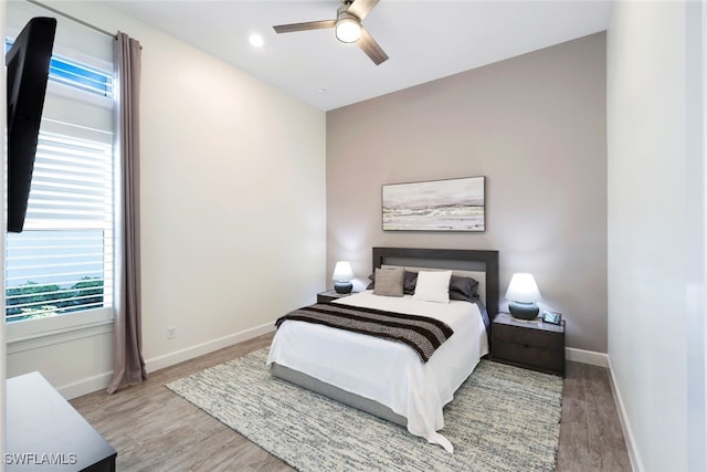 bedroom with light hardwood / wood-style flooring and ceiling fan