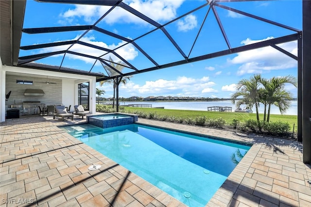 view of swimming pool featuring an in ground hot tub, ceiling fan, a water view, glass enclosure, and a patio area