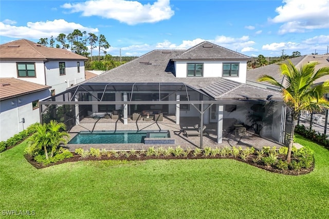 back of property featuring a lanai, a swimming pool with hot tub, a yard, and a patio