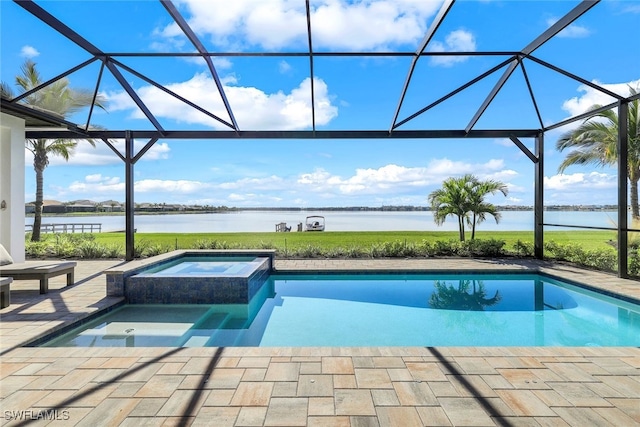 view of pool featuring an in ground hot tub, a water view, glass enclosure, and a patio area