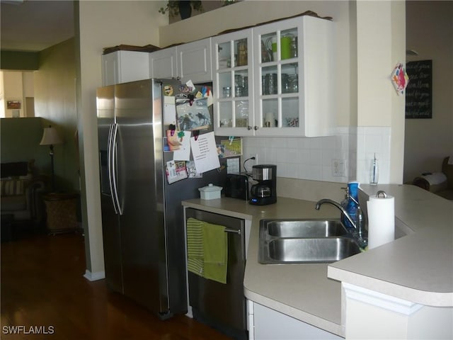 kitchen with white cabinetry, sink, appliances with stainless steel finishes, and tasteful backsplash